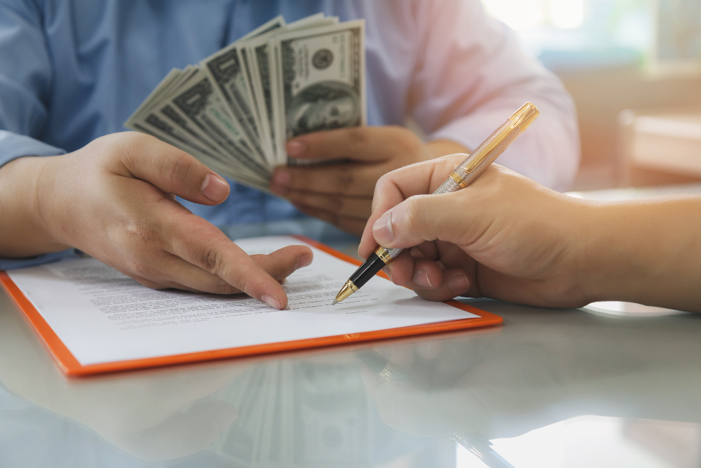 Signing a document for payday loans while exchanging money.